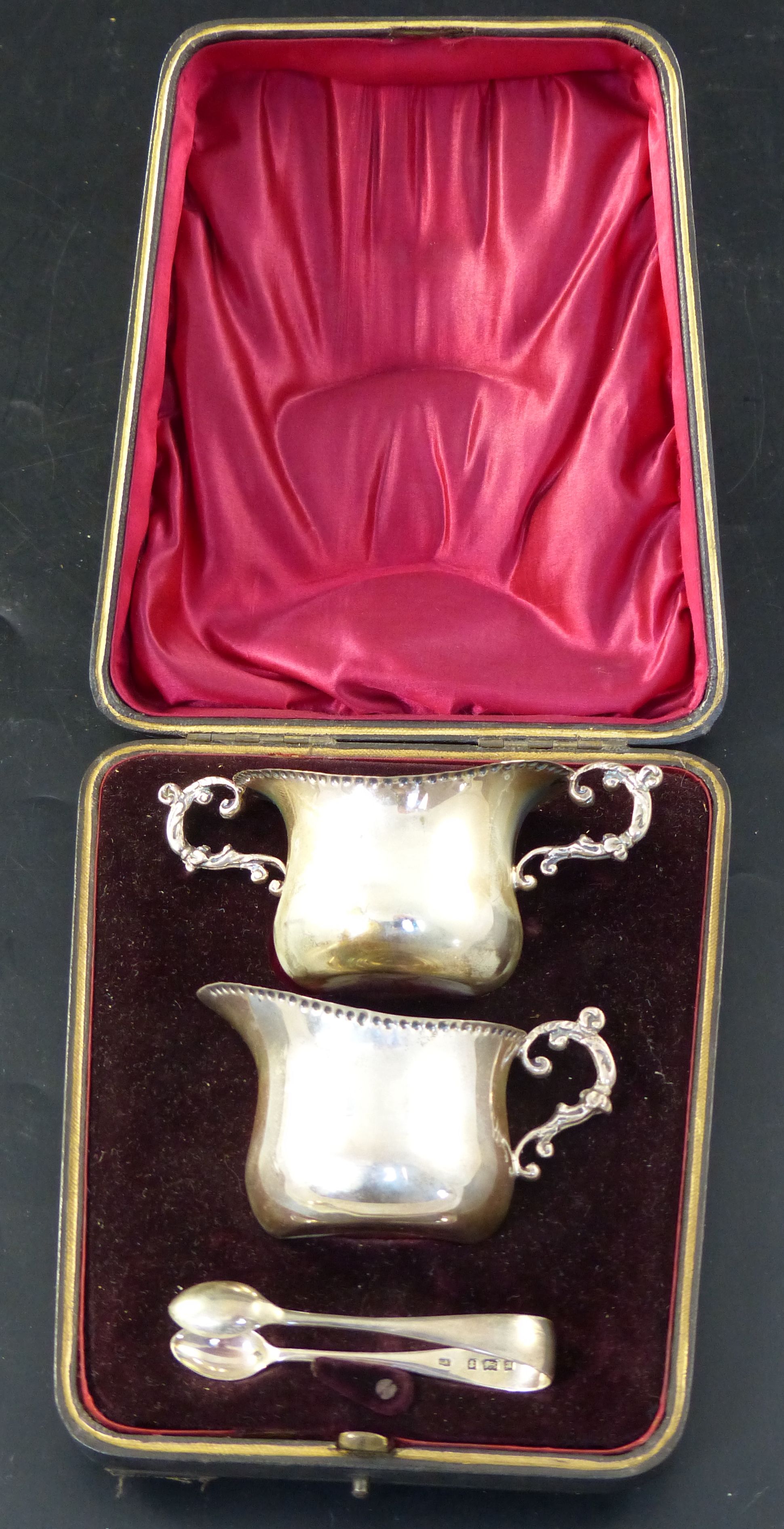 A late Victorian cased silver three piece cream and sugar set, 84 grams.